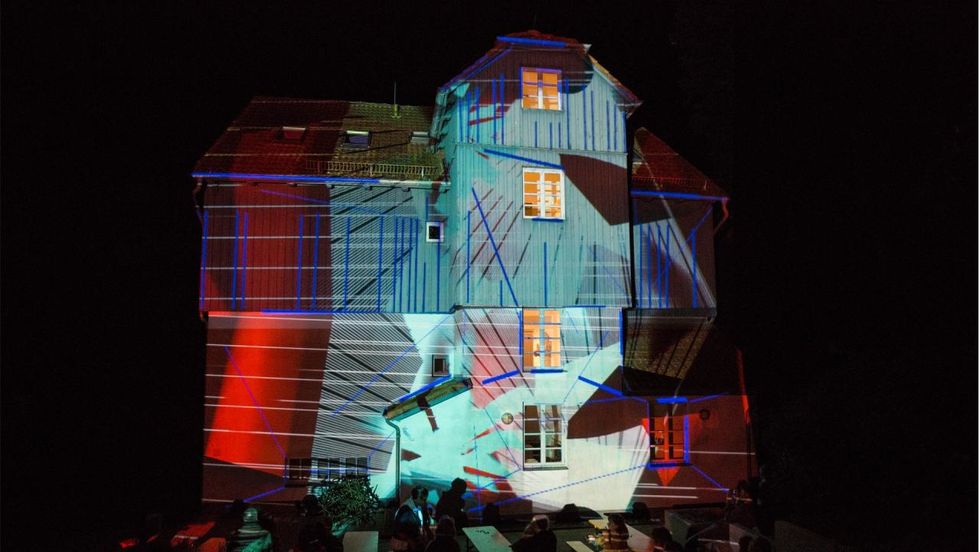 Künstlerhaus Lukas wrapped in light projection by Phillip Geist 